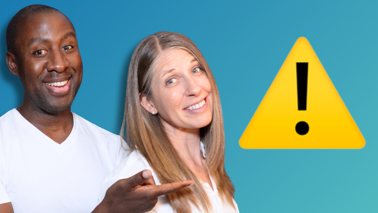 The image shows a smiling man in a white T-shirt pointing to a woman with long blonde hair in a white blouse. They are standing in front of a blue background, with a large yellow warning sign featuring an exclamation mark above and between them.